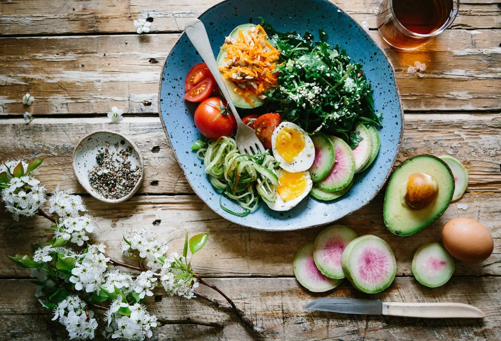 Healthy meal bowl with vegetables and eggs.